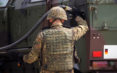 Soldier filling his truck with fuel