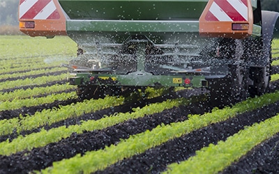 An agricultural implement moves through a field