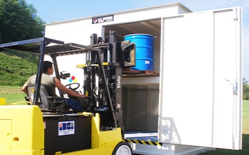 man using forklift to put flammable liquids into appropriate storage unit