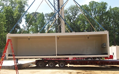 A modular chemical storage building from U.S. Chemical Storage is loaded to a truck.