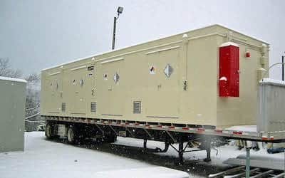 Chemical storage building on flatbed truck in snow