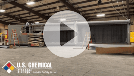 Play button overlaid on a screencap of a U.S. Chemical Storage warehouse, a man working on a chemical storage building