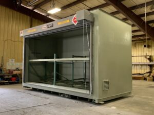 Angled photo of a two-level US Chemical Storage ethanol storage building for a distillery showing the ventilation and manual roll up door