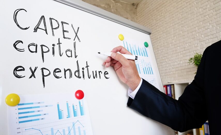 Photo of a man's arm writing "CAPEX capital expenditure" on a dry erase whiteboard
