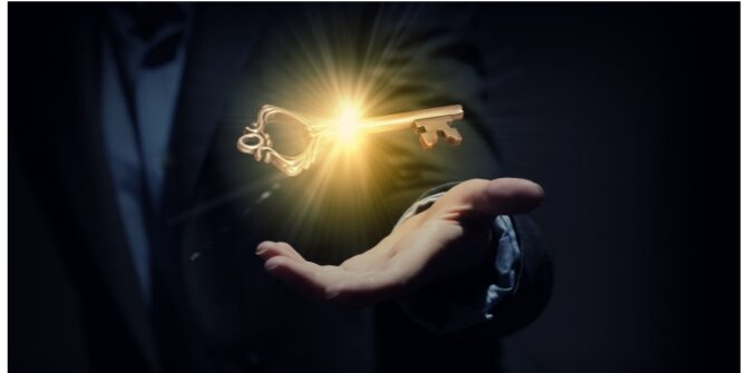  Man's Hand with a golden illuminated key floating above it