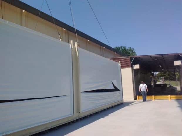 US Chemical Storage large rollup door building being offloaded by crane at project site for Mother Murphy's Laboratories