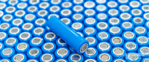 Dozens of blue wrapped lithium battery cells stacked tightly together